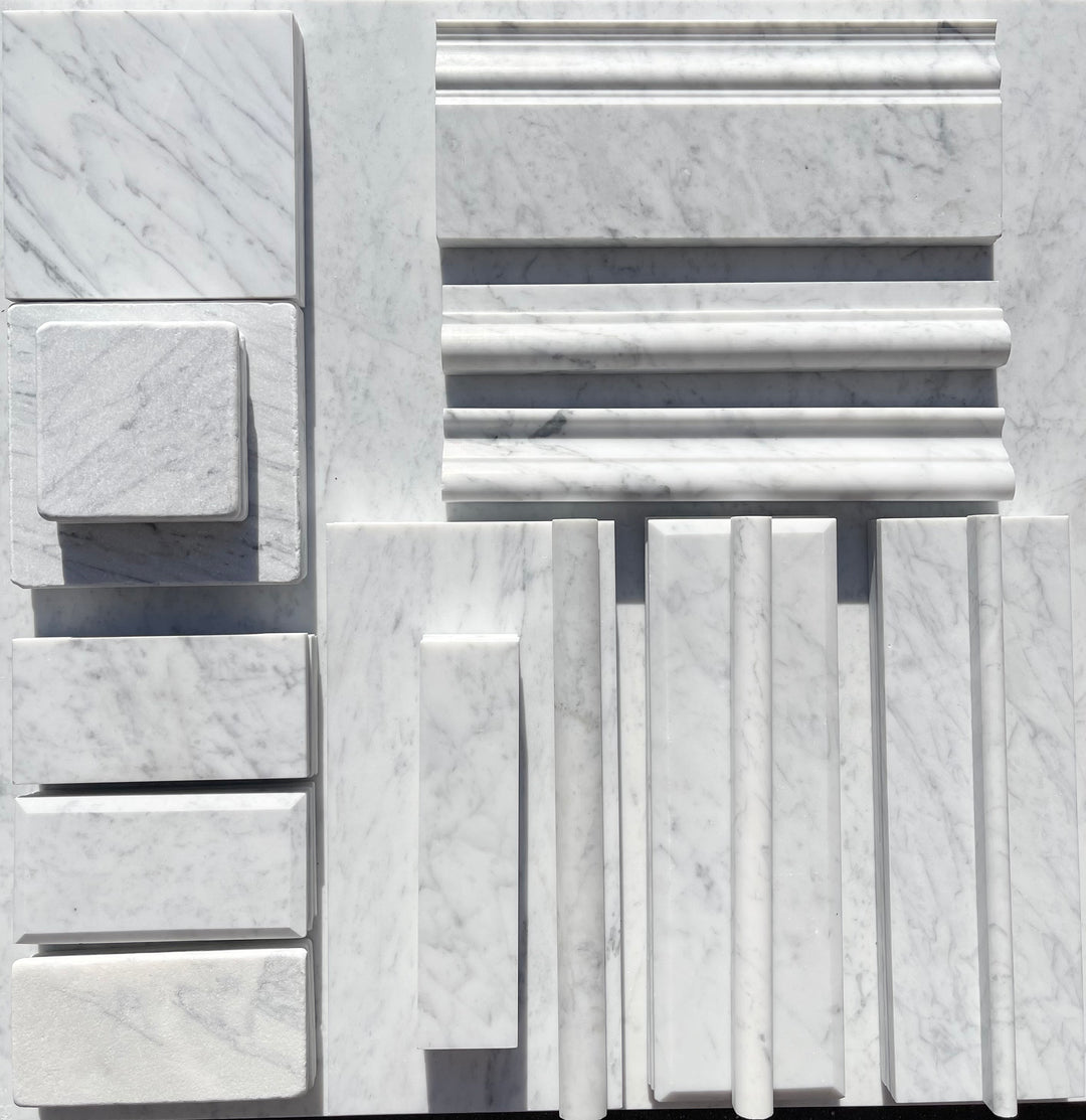 Italian Carrara White Marble samples: tiles, slabs, and moldings with subtle veining.