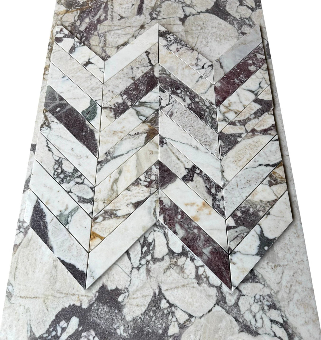 Calacatta Viola Marble 2x8 Chevron Mosaic tile sheet by Tilehouz, white marble with purple veining.