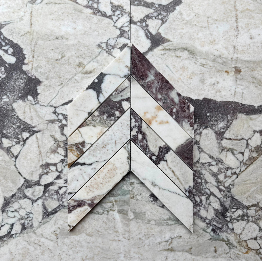 Calacatta Viola Marble 2x8 Chevron Mosaic wall tile by Tilehouz, white with purple veining.