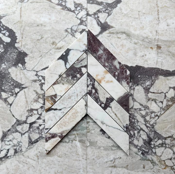 Calacatta Viola Marble 2x8 Chevron Mosaic wall tile by Tilehouz, white with purple veining.