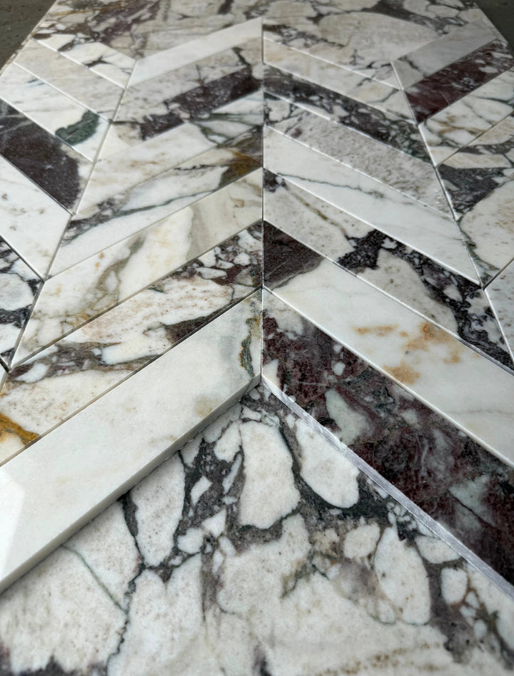 Calacatta Viola marble 2x8 chevron mosaic tile by Tilehouz for walls, white with purple veining