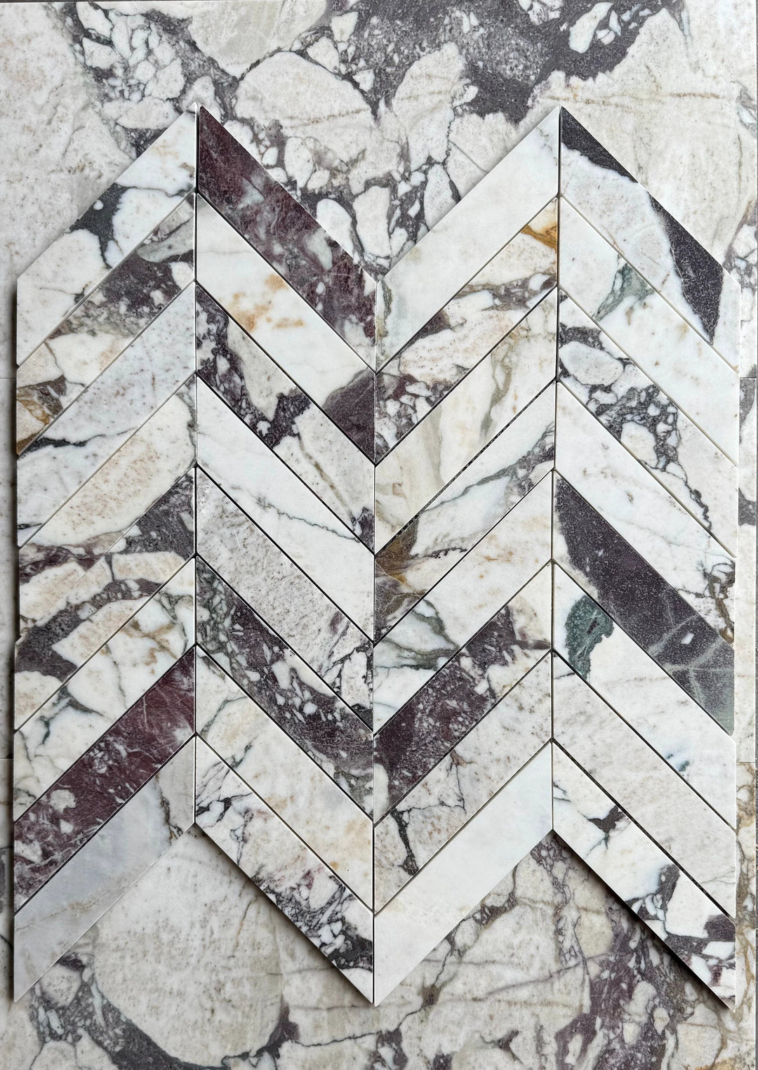 Calacatta Viola Marble 2x8 Chevron Mosaic tile by Tilehouz, wall tile with white and purple veining