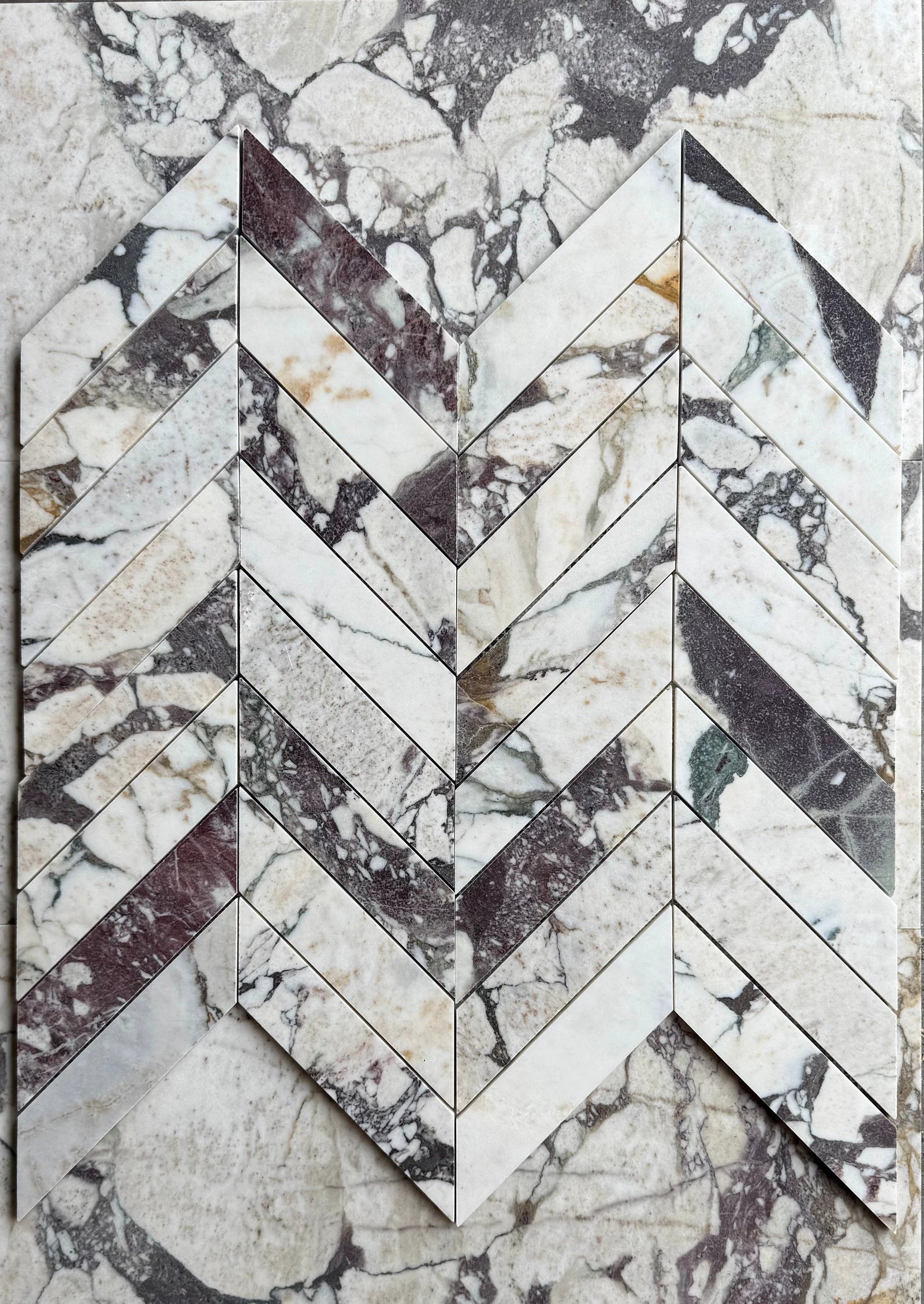 Calacatta Viola Marble 2x8 Chevron Mosaic tile by Tilehouz, wall tile with white and purple veining