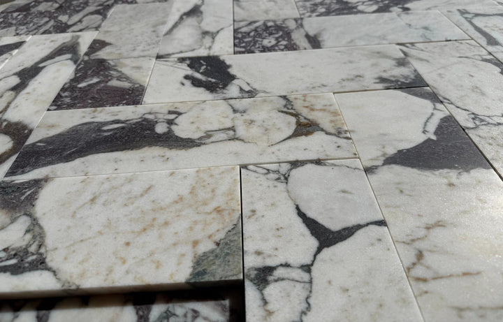 Calacatta Viola marble tile 4x12 by Tilehouz; white with dark gray veining, set of stacked tiles.