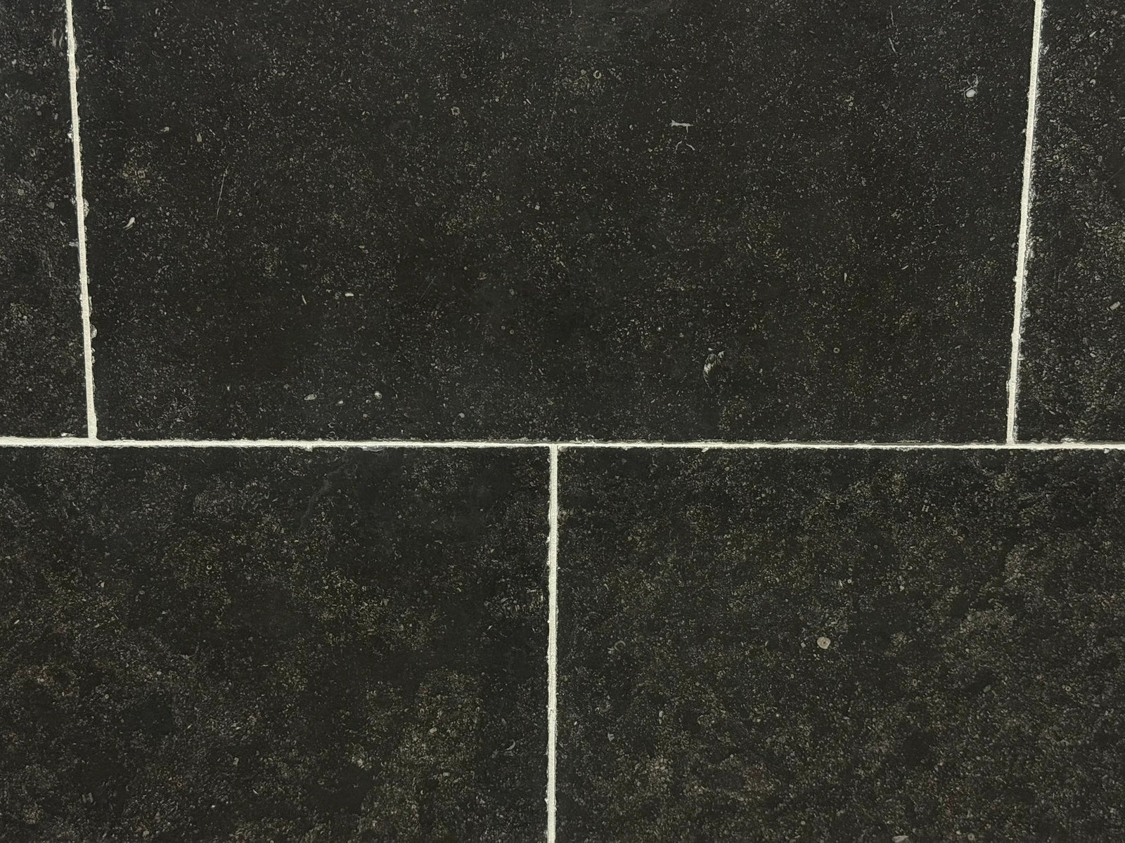 Pierre Bleu Belgian Limestone wall tile, 16x24 with antiqued edge; dark blue-black color, 4 tiles shown.