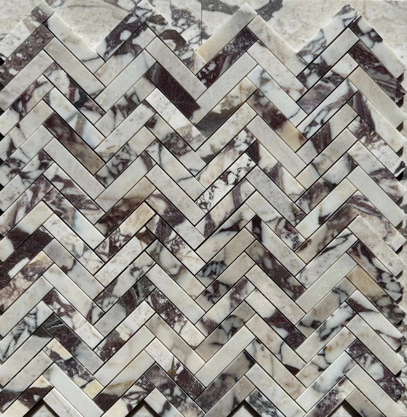 Calacatta Viola Marble 1x4 Herringbone Mosaic wall tile, white with purple veining.