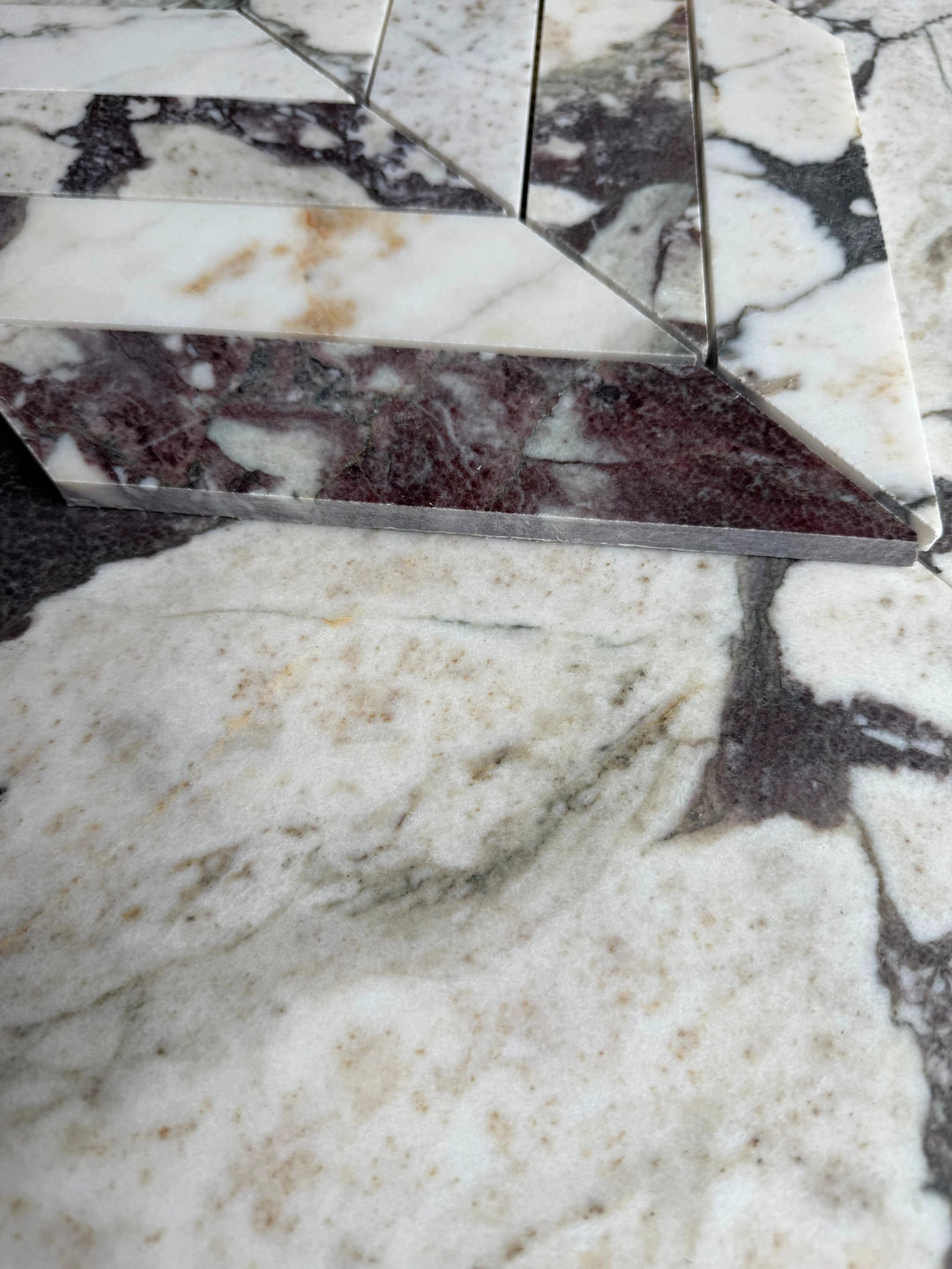 Calacatta Viola marble 2x8 chevron mosaic sheet by Tilehouz, white with purple veining for wall and ceiling tile