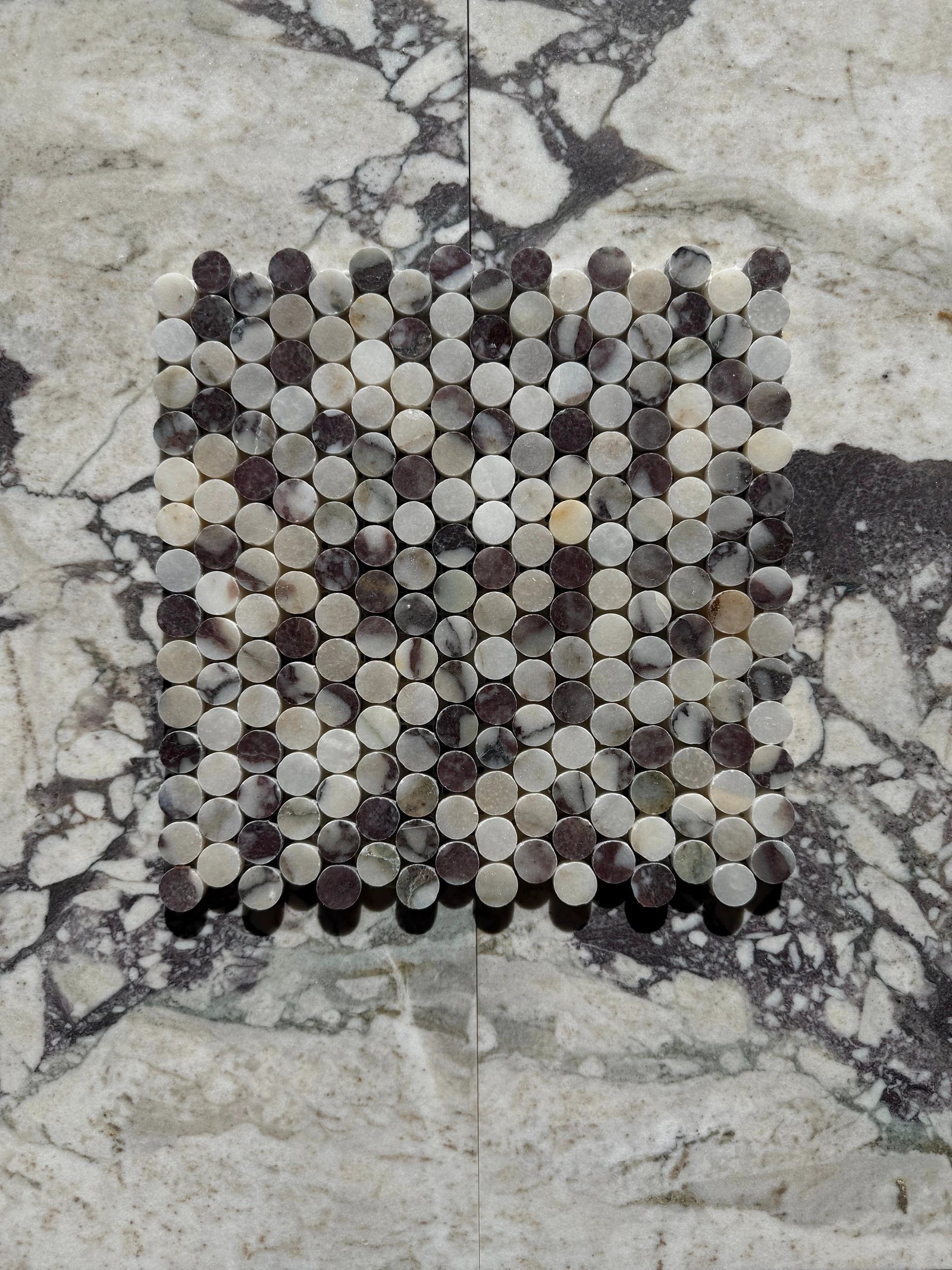 Calacatta Viola Marble Penny Mosaic by Tilehouz; round penny tiles in white, gray, and purple for wall & ceiling tile