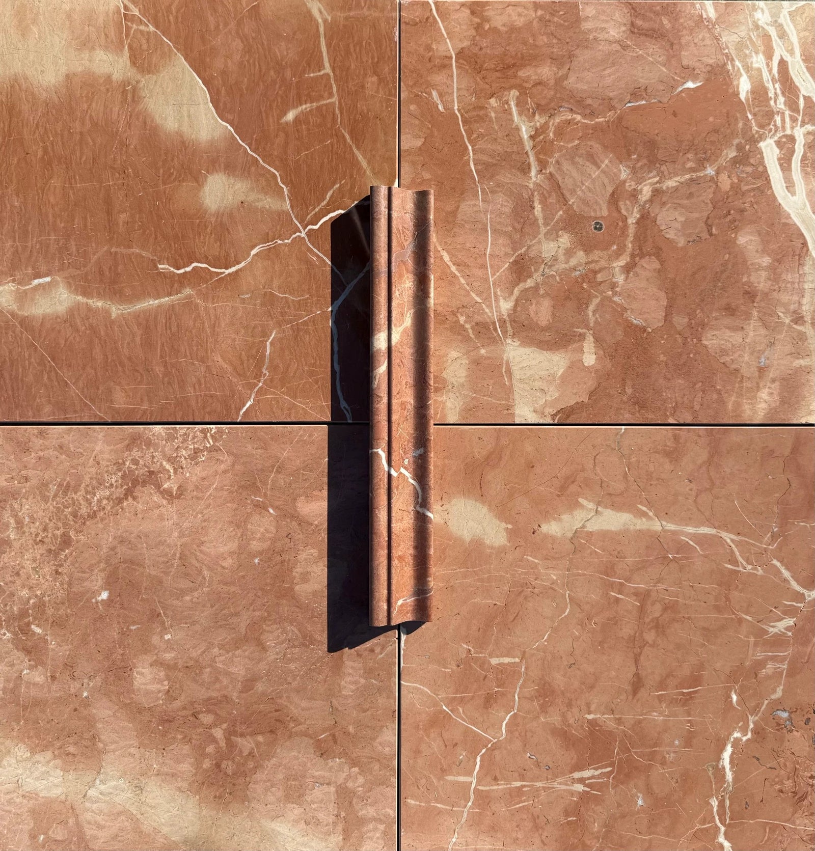 Rojo Alicante Marble chair rail molding by Tilehouz, reddish-brown with white veining