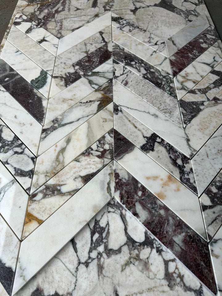 Calacatta Viola marble 2x8 chevron mosaic tile for walls and ceilings in white, gray, and purple veining