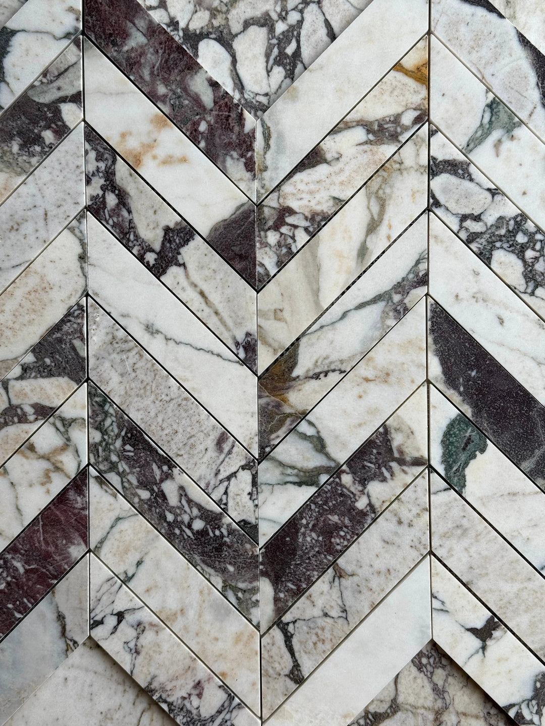 Calacatta Viola Marble 2x8 Chevron Mosaic tile by Tilehouz; white with purple veining for wall/ceiling.