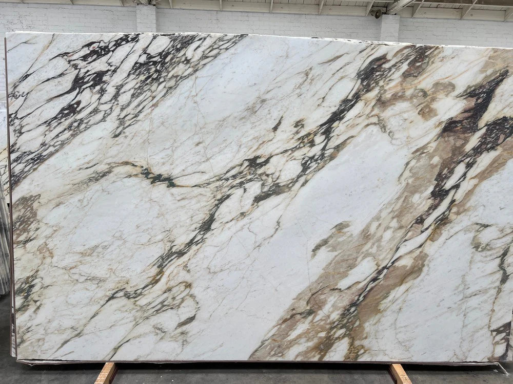 Marble slab CALACATTA VIOLA SUPREME honed; white with bold gray and beige veining, 127 x 80, Tilehouz countertop.