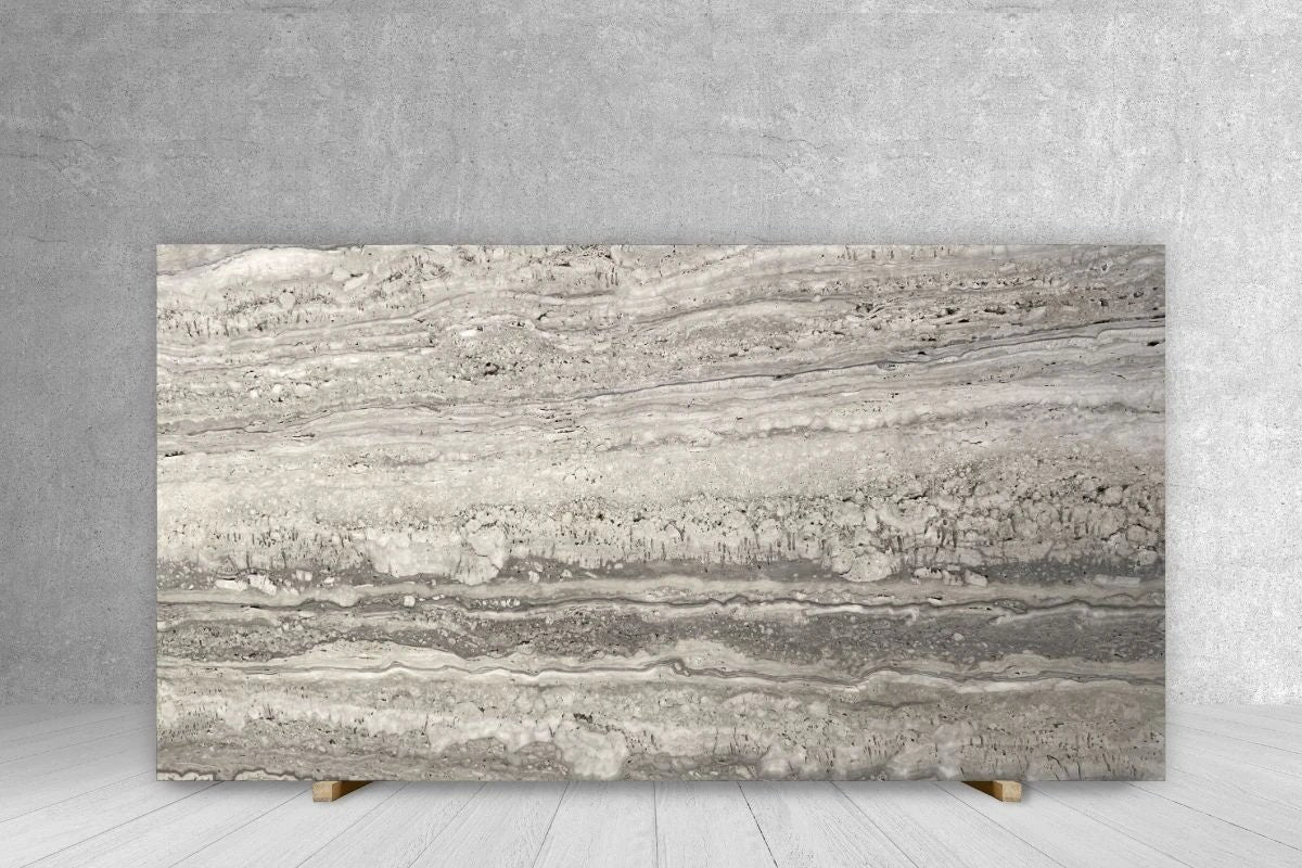Travertine slab countertop in silver-gray with layered banding; extra honed, unfilled, 108x67