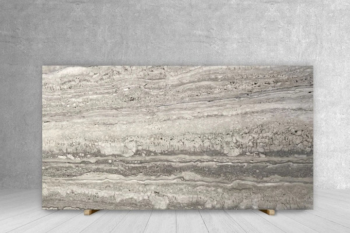 Travertine slab countertop in silver-gray with layered banding; extra honed, unfilled, 108x67
