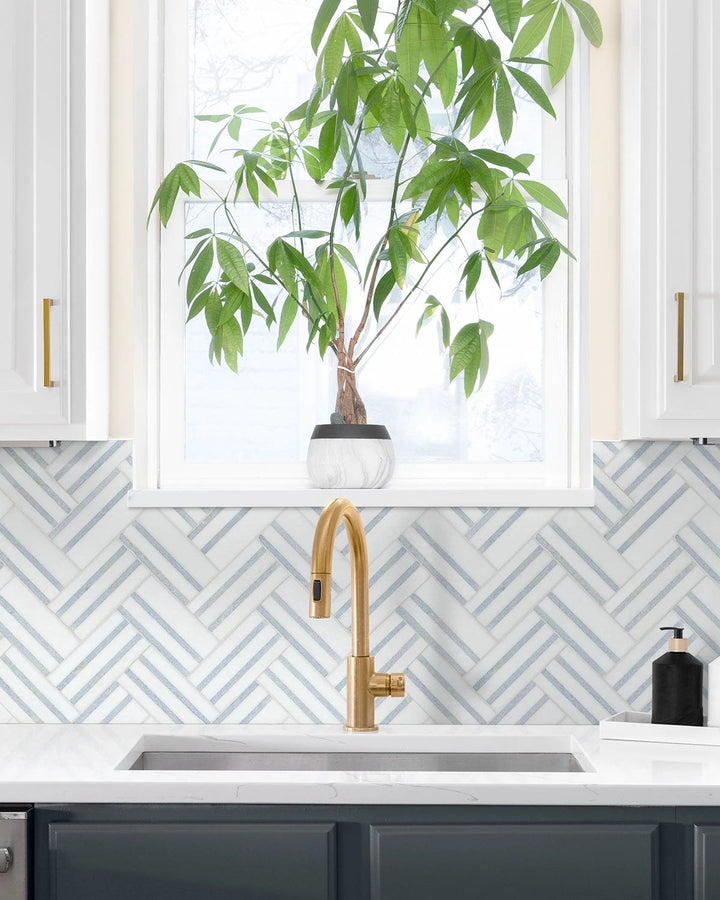 Azula Linea Polished Mosaic marble wall tile sheet in a light gray herringbone backsplash