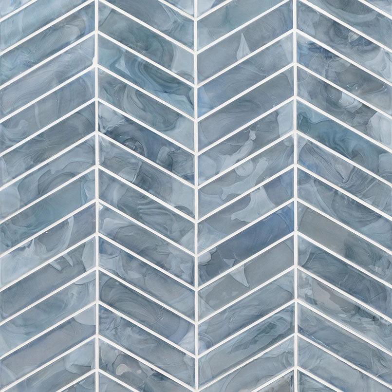 Blue Storm Glass Chevron Mosaic tile by Tilehouz; blue pearl-gloss glass wall tile with white chevron grout