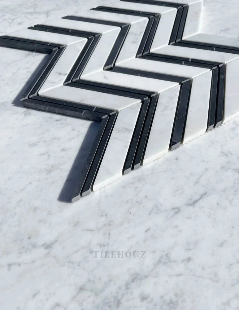 Carrara White Marble large chevron mosaic tile by Tilehouz with black thin strips; polished and honed finish