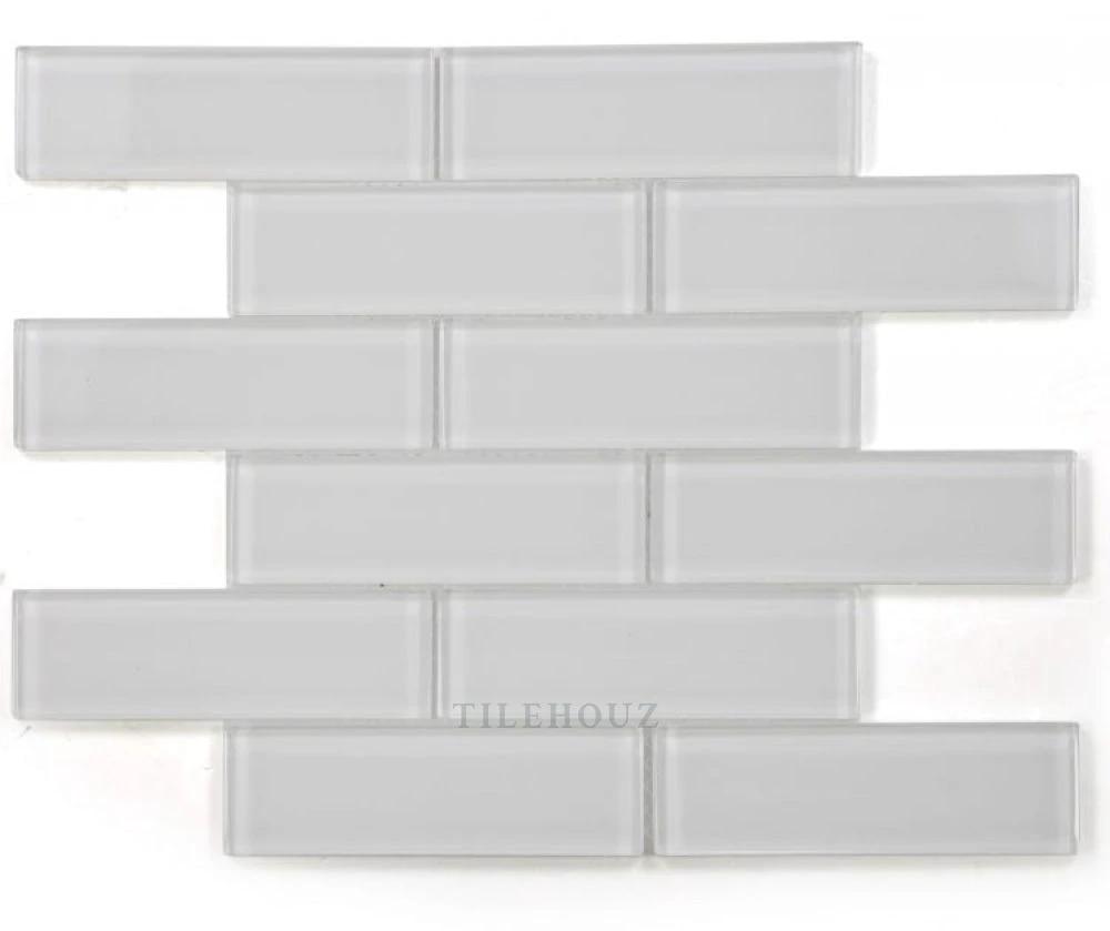 Tilehouz Casale White Shining glass mosaic sheet; polished white brick-pattern tiles for walls and ceilings.