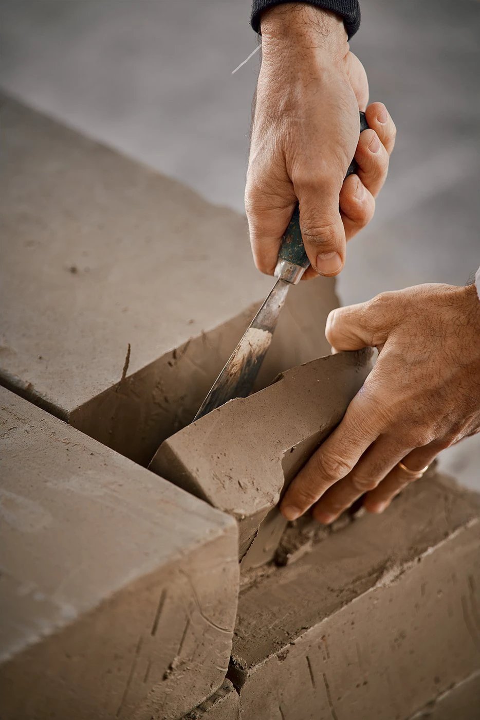 Tilehouz Terracreta Argilla porcelain hexagon wall tile being cut by a mason