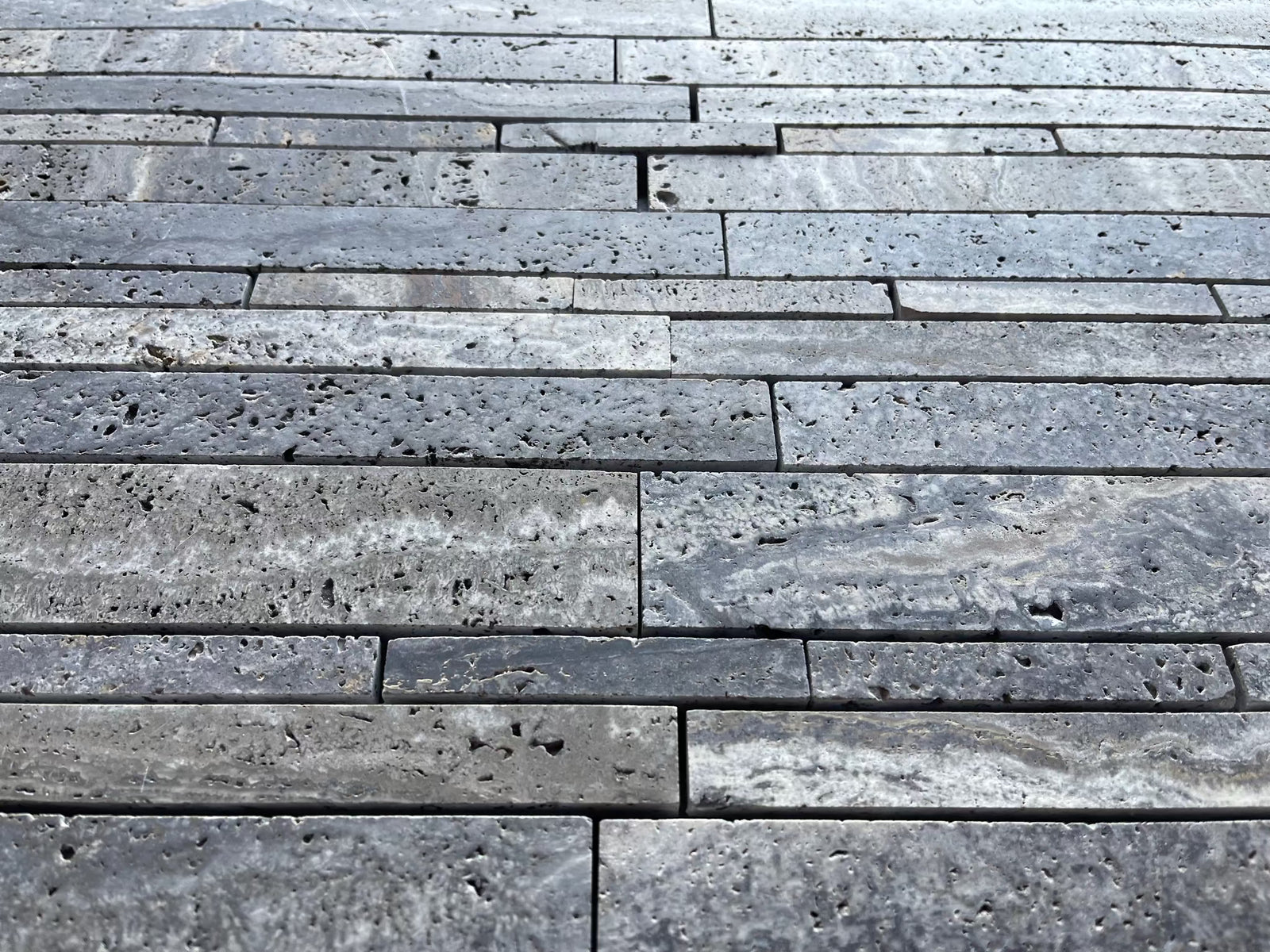 Blue travertine random-strip mosaic wall tile with brushed and semi-polished finish